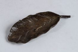 A JAPANESE BRONZE MAGGOT ON A LEAF. 5ins long.