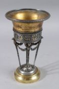 A PALAIS ROYAL TWO COLOUR URN on winged legs and circular base. 9.5ins high.