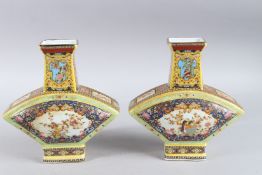 A PAIR OF COLOURFUL CHINESE PORCELAIN VASES. 9ins high.