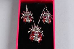A SILVER, ENAMEL AND RUBY SET LADYBUG NECKLACE AND EARRING SET.