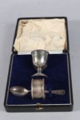 A CASED SILVER CHRISTENING SET, egg cup, spoon and serviette ring. Sheffield 1935.
