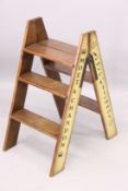 A PAIR OF CHAMPAGNE FOLDING WOOD LADDERS. 2ft 2ins x 2ft 2ins.