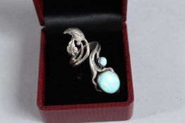 A SILVER AND OPAL ART NOUVEAU STYLE RING.