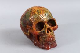A CARVED AMBER SKULL. 6ins high.