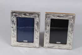A PAIR OF SILVER PHOTOGRAPH FRAMES. 7.5ins x 5.5ins.