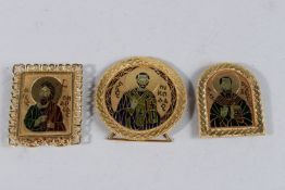 THREE 18CT GOLD MINIATURE ICONS with saints in enamel. Weight 60grms.