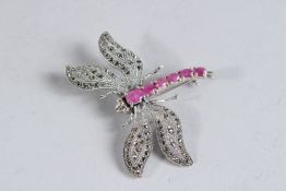 A SILVER, RUBY AND MARCASITE DRAGONFLY BROOCH.