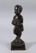 A SMALL 19TH CENTURY BRONZE OF A YOUNG GIRL holding a basket of fruit, on a square base. 11ins
