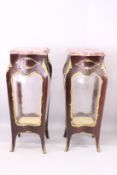 A GOOD PAIR OF LOUIS XVITH STYLE SHAPED MARBLE TOP VITRINES with ornate mounts and glass sides.