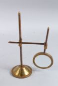 A MAGNIFYING GLASS on a stand.