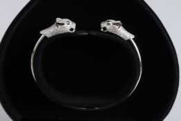 A SILVER DOUBLE PANTHER HEAD BANGLE.