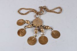 A GILT NECKLACE set with five gilt coins.