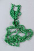 A VERY GOOD JADE NECKLACE of five rows and tassel with 14ct gold clasp.