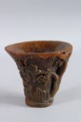 A GOOD CHINESE CARVED HORN LIBATION CUP with figures, birds and foliage. 5.5ins long.