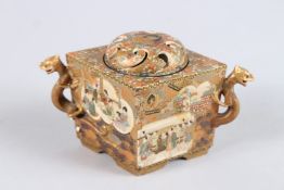 A JAPANESE SATSUMA DIAMOND SHAPED CENSER AND COVER with panels of figures and vases, with pierced