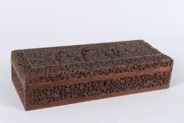 A FINE 19TH CENTURY ANGLO INDIAN CARVED SANDALWOOD BOX with Hindu deities amongst foliage. 12ins