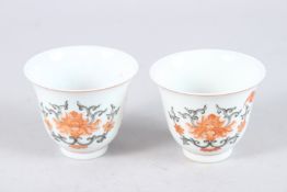 A SMALL PAIR OF CHINESE PORCELAIN TEACUPS painted with bats. 2.75ins high.