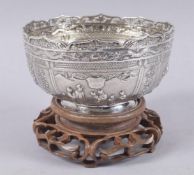 A VERY FINE CHINESE WING FAT EMBOSSED SILVER BOWL ON HARDWOOD STAND, with finely chased relief