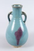 A CHINESE JUN WARE TWIN HANDLED POTTERY VASE, with turquoise glaze. 26cms high.