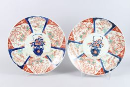 A PAIR OF LARGE JAPANESE IMARI CHARGERS, painted with a basket of flowers to the centre, within