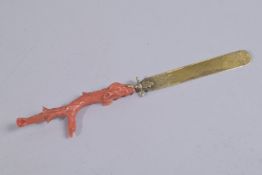 A VERY FINE 19TH CENTURY CARVED CORAL AND GILT METAL PAGE TURNER, 20cms long.