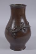 A CHINESE BRONZE VASE WITH RELIEF CHILONG, 28cms high.