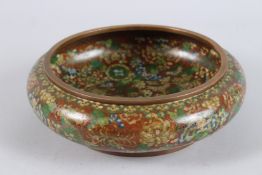 AN EARLY / MID 20TH CENTURY JAPANESE CLOISONNE CIRCULAR BOWL, with an allover floral design. 25cms