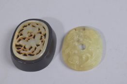 A FINE CHINESE CARVED AND PIERCED JADE AMULET ON HARDWOOD STAND, amulet 6.5cms x 5cms, together with