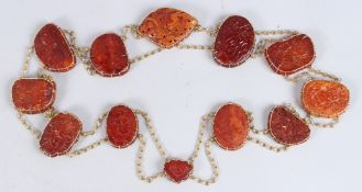 A SUPERB CHINESE GOLD AND AMBER CHAIN set with twelve amber panels carved with Chinese scenes,
