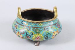 A CHINESE CLOISONNE TWIN HANDLED TRIPOD CENSER, with floral decoration to the melon form body,