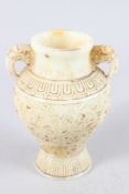 A CHINESE CARVED TWO HANDLED WHITE JADE VASE. 8ins high.