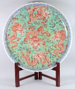 A MASSIVE CHINESE CIRCULAR DISH in coloured enamels with dragon mark in blue. 38ins diameter.