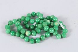A STRING OF JADE BEADS. 34ins long.