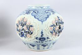 A LARGE FINE CHINESE BLUE AND WHITE JAR with flowers in relief, with underglaze in red and blue.