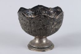 A 19TH CENTURY CHINESE SILVER PEDESTAL BOWL, with a shaped rim, embossed and chased with panels of