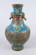 A CHINESE CLOISONNE BOTTLE SHAPE VASE, with elephant head handles, decorated with bunches of