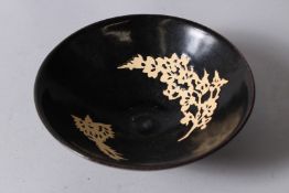 A CHINESE JIZHOU KILN POTTERY BOWL, rich brown ground incised with a bird and branch design. 16cms
