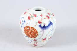 A SMALL CHINESE BULBOUS VASE painted with bats and peaches. 3.5ins high.