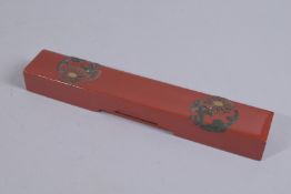 A FINE RED LACQUER PEN BOX CONTAINING SILVER PEN, 24cms long.