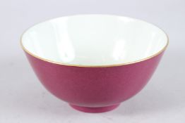 A CHINESE PINK GLAZE FAMILLE ROSE BOWL with peaches. 5.5ins diameter.