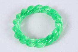 A CHINESE APPLE GREEN JADE TWIT BANGLE. 3.5ins diameter.