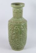A CHINESE TALL GREEN PORCELAIN VASE with figures in relief. 24ins high.