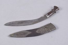 A NEPALESE METAL AND LEATHER MOUNTED KUKRI, 35cms long.