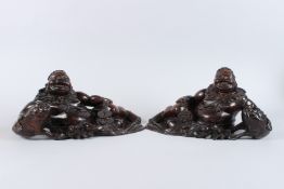 A VERY GOOD PAIR OF CARVED WOOD RECLINING FIGURES, foo dogs at the side. 15cms long x 7cms high.