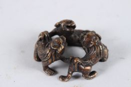 A BRONZE ROUNDEL, THREE DOGS. 2ins diameter.