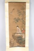 A CHINESE SCROLL PAINTING, depicting a female musician with attendant seated beneath a tree.