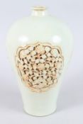 A CHINESE WHITE GLAZE MEIPING carved with three panels of flowers. 12ins high.