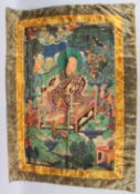 A TIBETAN THANGKA on silk. 32ins x 42ins.