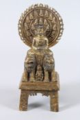 A 19TH CENTURY SINO TIBETAN GILT BRONZE FIGURE OF A BUDDHA, with halo, seated on a pair of lions, on