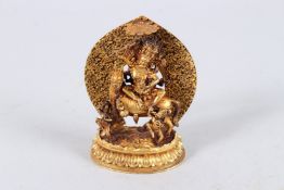 A FINE TIBETAN GOLD PLATED BUDDHA seated on a horse. 4ins high.